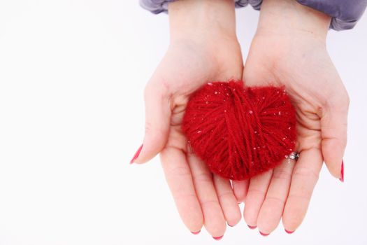  woman holding red Wool heart in hand