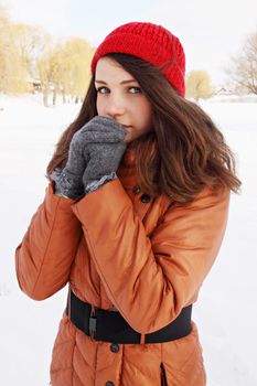 woman cold outdoors, warming his hands winter 