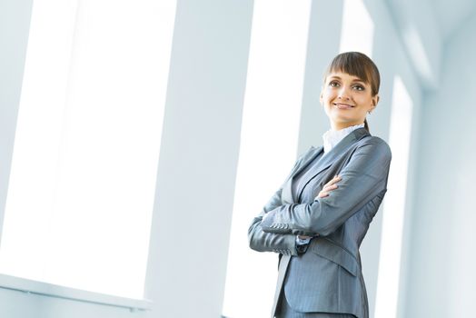 young modern business woman, crossed her arms and smiles