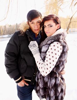 Young beautiful couple on nature in winter
