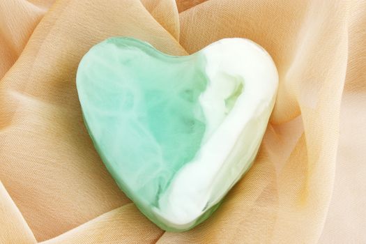 Green  soap in the form of the heart  on the cloth