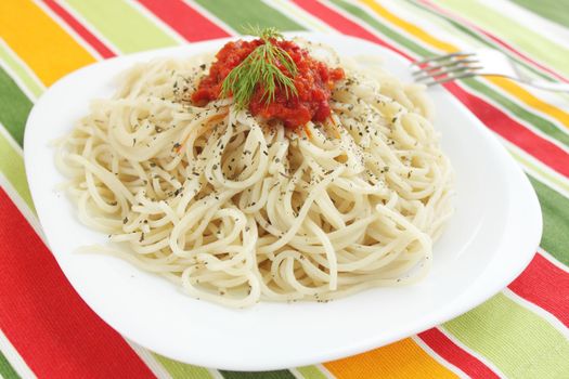 Spaghetti with the tomato sauce on the white plate