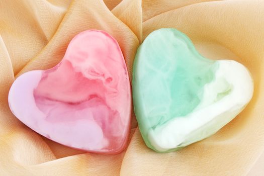 Two pieces of soap in the form of heart on the cloth