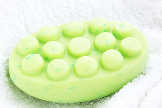 green anticellulite soap on the white towel