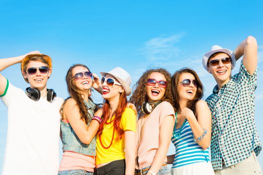 group of young people wearing sunglasses and hats hugging and standing in a row, spending time with friends