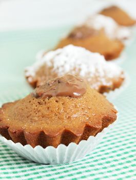 Group of chocolate cupcakes on the tablecloth