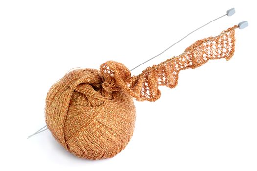 Ball of threads and knitting needle against the white background