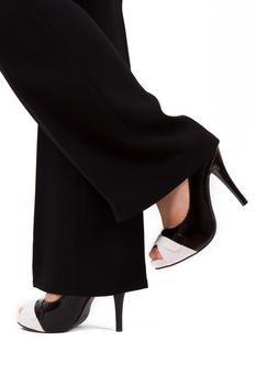 Young business woman with dark suit shows her feet and shoes.