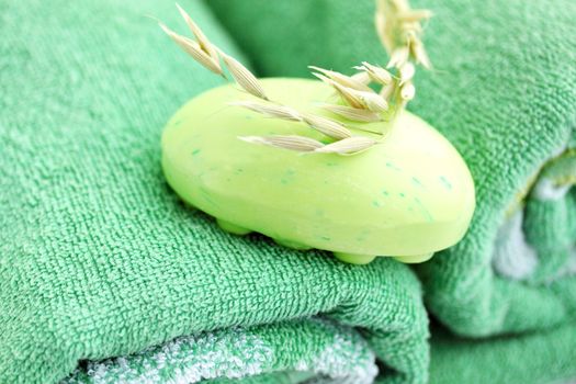 Light-green  soap with the oats on the green towel
