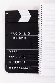 Black cinema clapper board and notebook for scenario, isolated on white background.