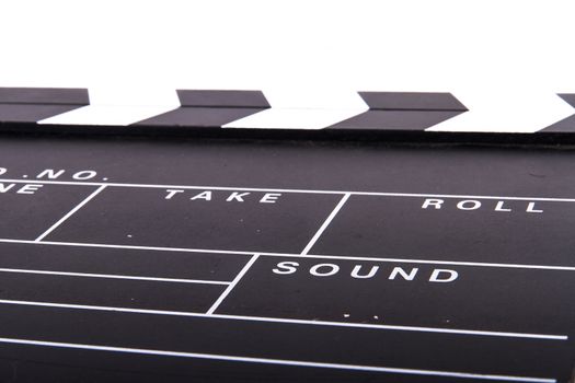 Close up of blank black film clapper board, isolated on white background.