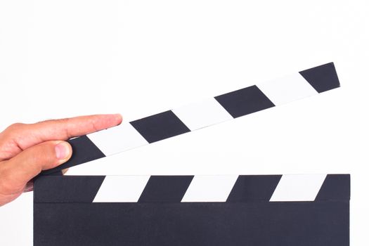 Hand holding and opening black cinema clapper board, isolated on white background.