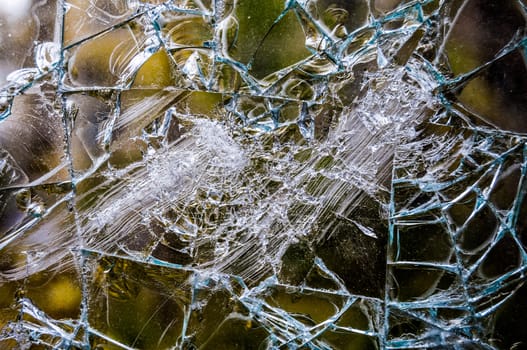closeup of a window shattered in many pieces