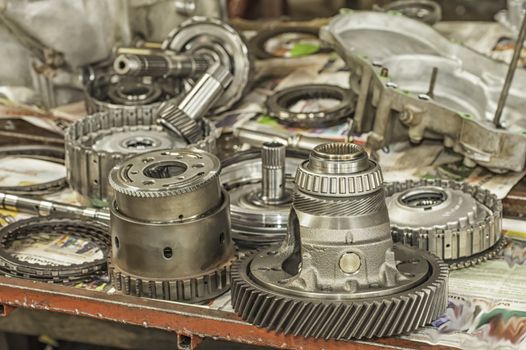 Used automatic transmission parts on a workbench.