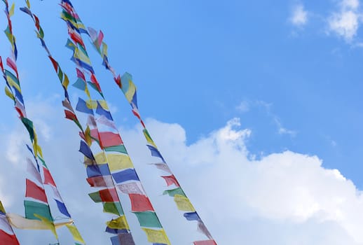bodhnath stupa in kathmandu with prayer flags on clear blue sky background