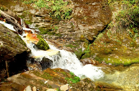 Water stream movement on the stone background, Nepal Himalayan forest 
