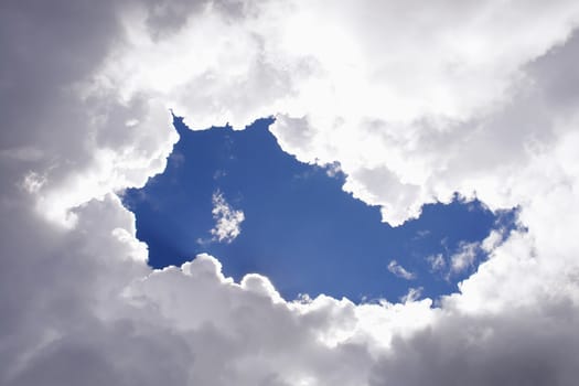 sunlight rays and clouds on the blue sky background