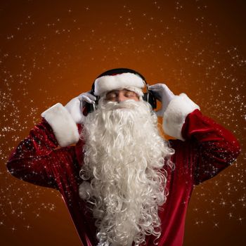 Santa Claus is listening to music on headphones, behind the abstract background