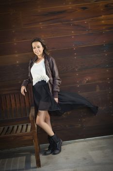 Portrait of a Pretty Mixed Race Young Adult Woman Against a Lustrous Wooden Wall Background.