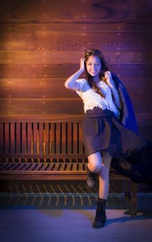 Portrait of a Pretty Mixed Race Young Adult Woman Against a Lustrous Wooden Wall Background.