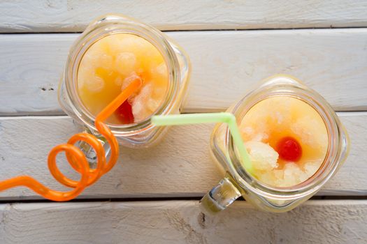 Homemade fruits slush in a jar with a straw