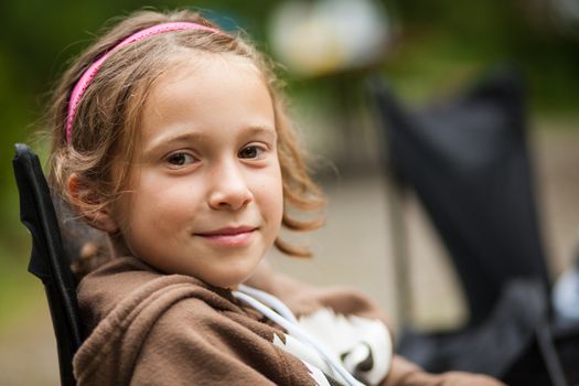 Girl smiling while sitting outdoor