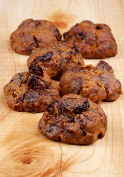 Arrangement of Delicious Cookies with Chocolate Chip and Raisins closeup on Wooden background