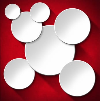 Some white empty circles with shadows on red velvet background