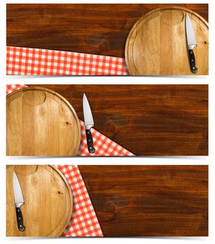Cooking banners with round cutting board, red checked tablecloth on wooden table and kitchen knife isolated on white

