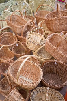 Full frame take of a heap of wickerwork baskets at a traditional street market stall