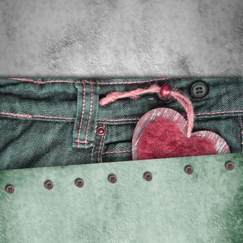 background young lovers, heart in jeans pocket on paper background with empty space for text