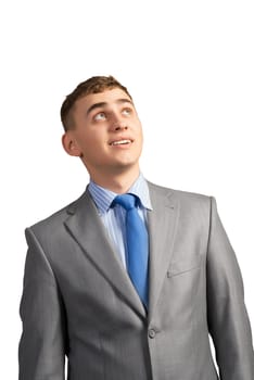 portrait of a young businessman thinking and looking up on gray background, isolated on white background