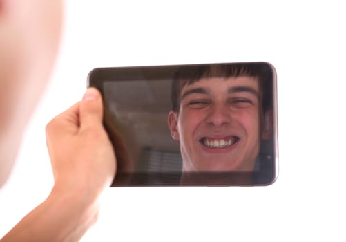 Reflection of Young Man Face in Display of Tablet Computer Isolated on the White Background