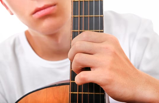 Teenager with Acoustic Guitar on the White Background Closeup