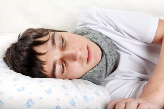 Diseased Young Man lying on the Bed