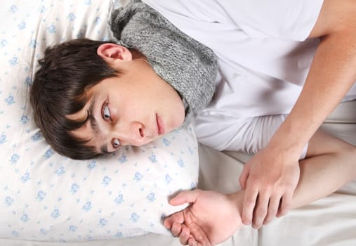 Diseased Young Man lying on the Bed