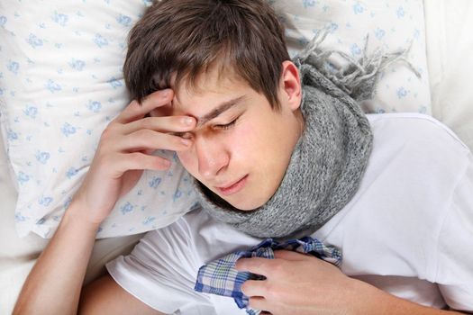 Sick Young Man feels Headache and lying on the Bed