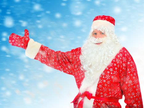 Santa Claus shows the way with a hand on the Abstract Winter Background