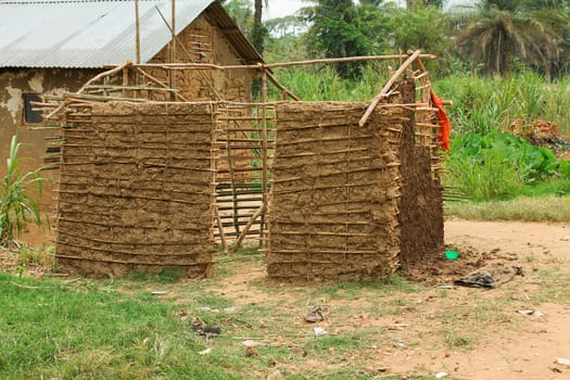 Unfinished pygmy hut stands in a clearing in an African village