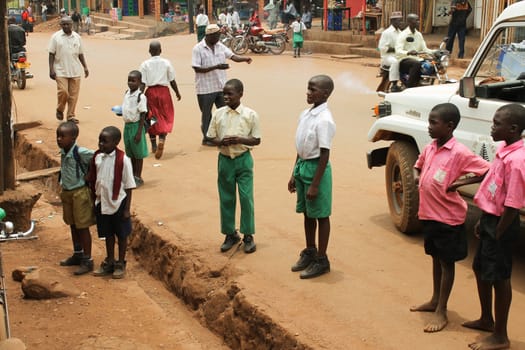 Uganda - March 5: African children stand on the street in the city and carefully what observe 5 March 2012 in Uganda.