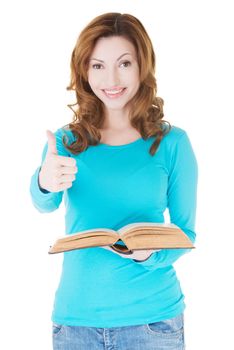 Beautiful casual woman holding a book and showing OK. Isolated on white.
