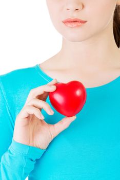 Attractive woman holding a heart, closeup. Isolated on white.