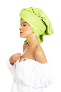Attractive woman wrapped in towel with turban. Trying to undress her. Side view. Isolated on white.