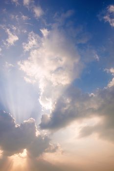 sunlight rays and clouds on the blue sky background