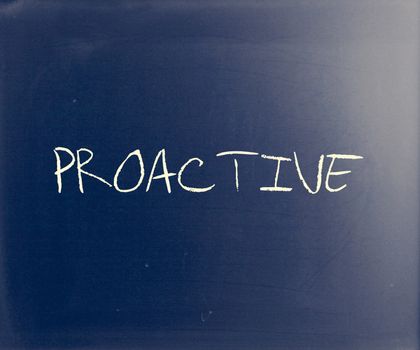 The word 'Proactive' handwritten with white chalk on a blackboard.
