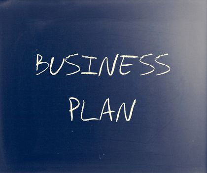 "Business plan" handwritten with white chalk on a blackboard.