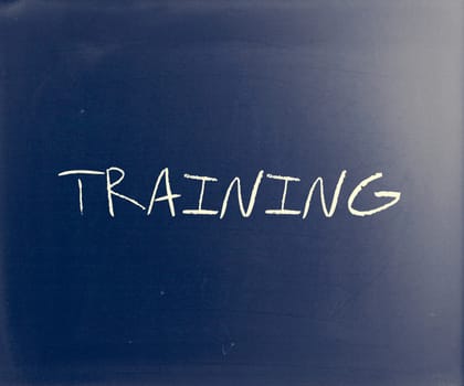 "Training" handwritten with white chalk on a blackboard.