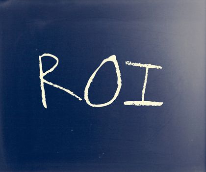 "ROI" handwritten with white chalk on a blackboard.