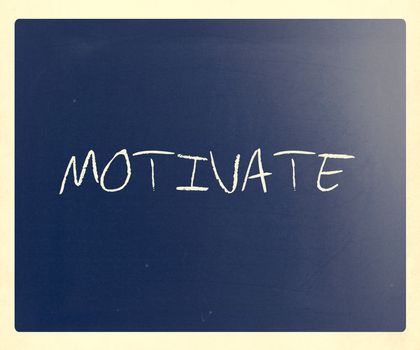 "Motivate" handwritten with white chalk on a blackboard.