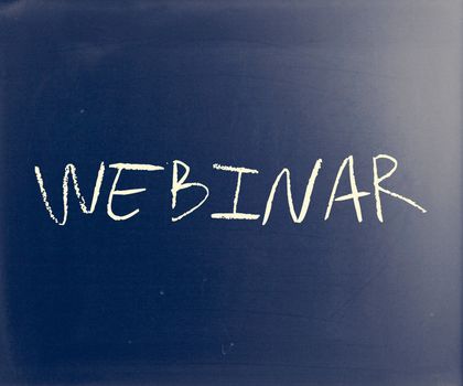 "Webinar" handwritten with white chalk on a blackboard.